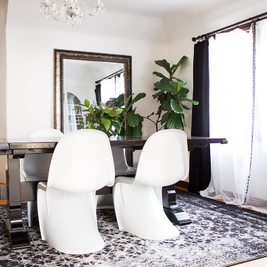 my copycatchic home tour: The dinging room update. A transitional dining room in black, white and gray with a vintage looking rug and modern chairs.